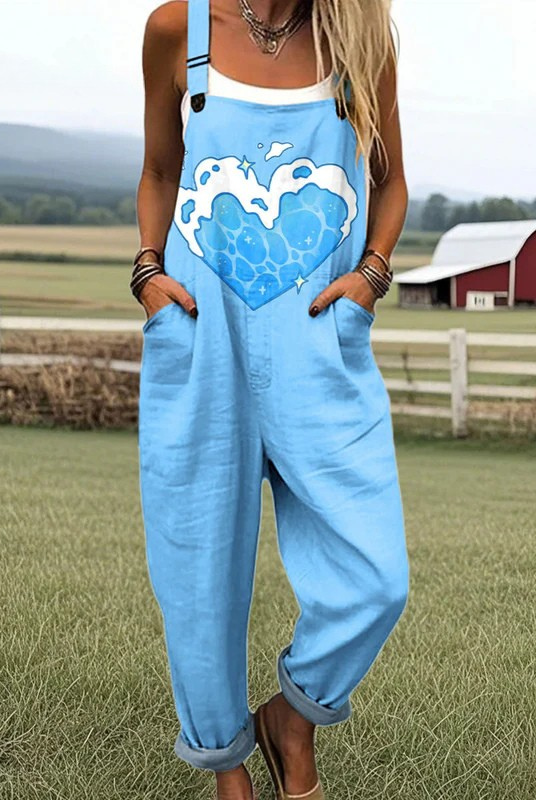 Front view of the light blue Briar Cloud Heart Jumpsuit, featuring a large white heart graphic with cloud accents, styled on a mannequin.