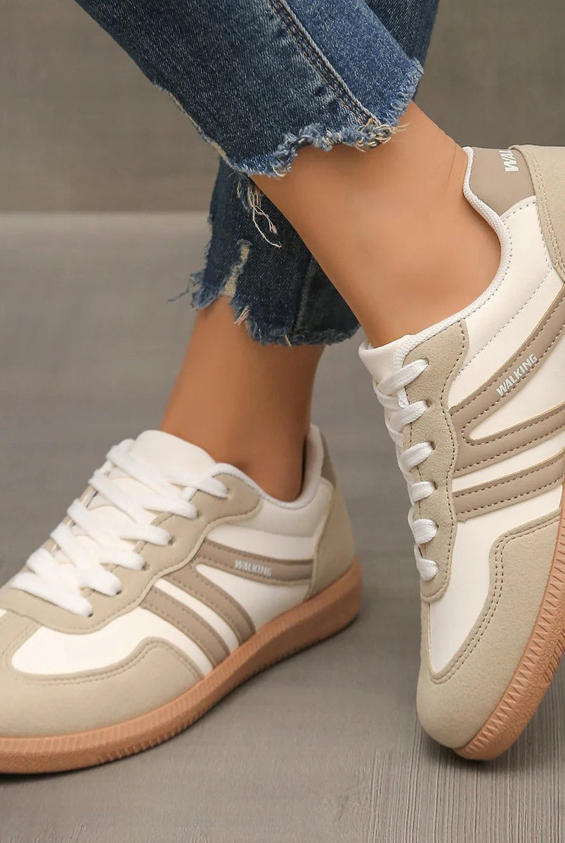 Side view of off-white Briony orthopaedic trainers with subtle branding on a clean background.