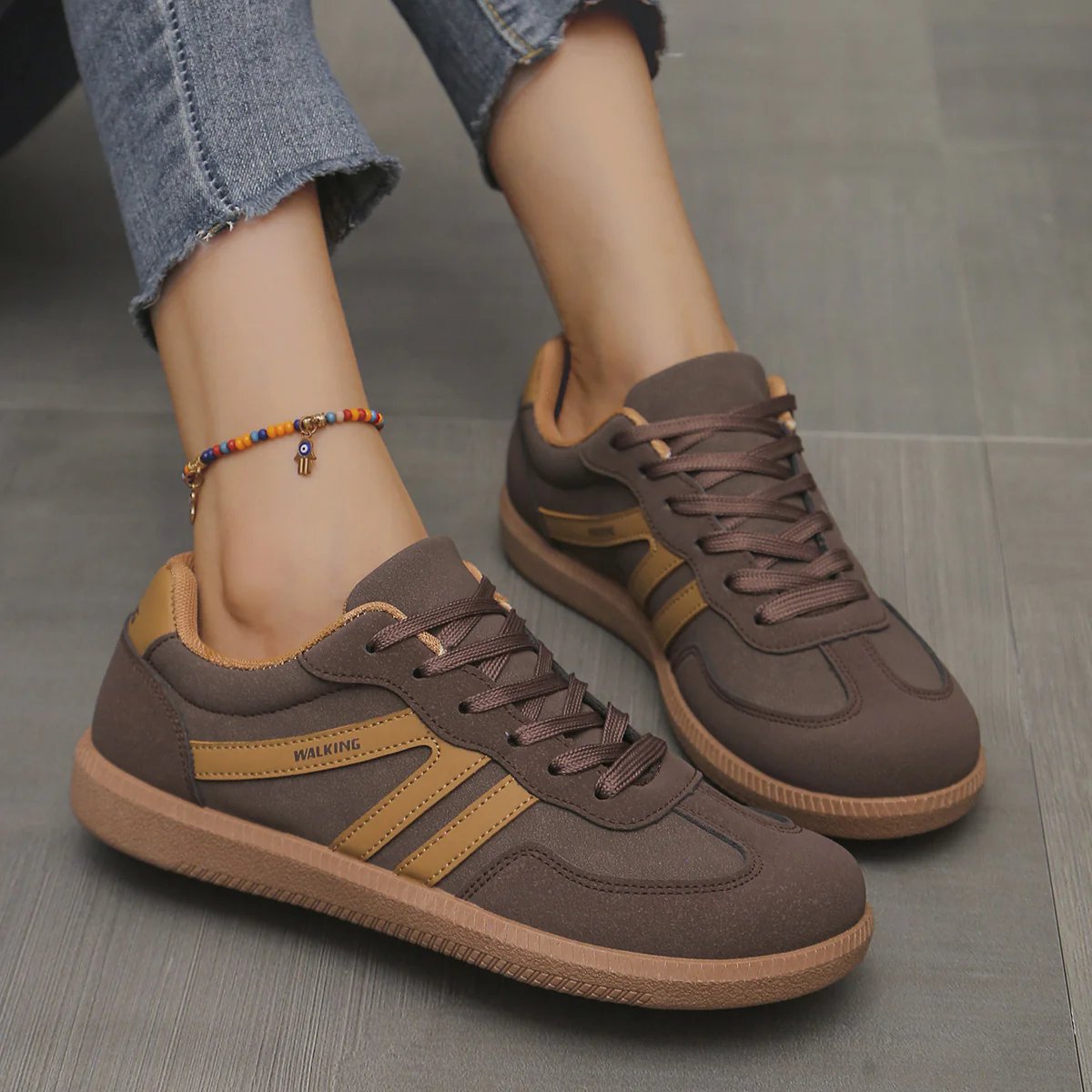A person's feet wearing off-white Briony trainers, demonstrating comfortable posture during a walk.
