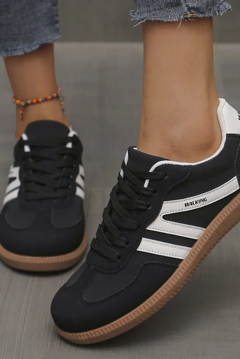 Front angle of off-white cushioned trainers, showcasing the breathable upper material and lace detail.
