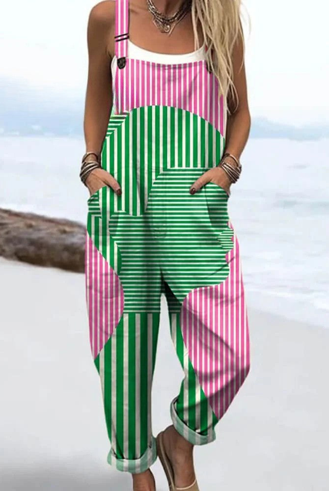 Front view of the Calla artistic abstract jumpsuit, featuring a striking pink and green geometric pattern with a central human figure outline.