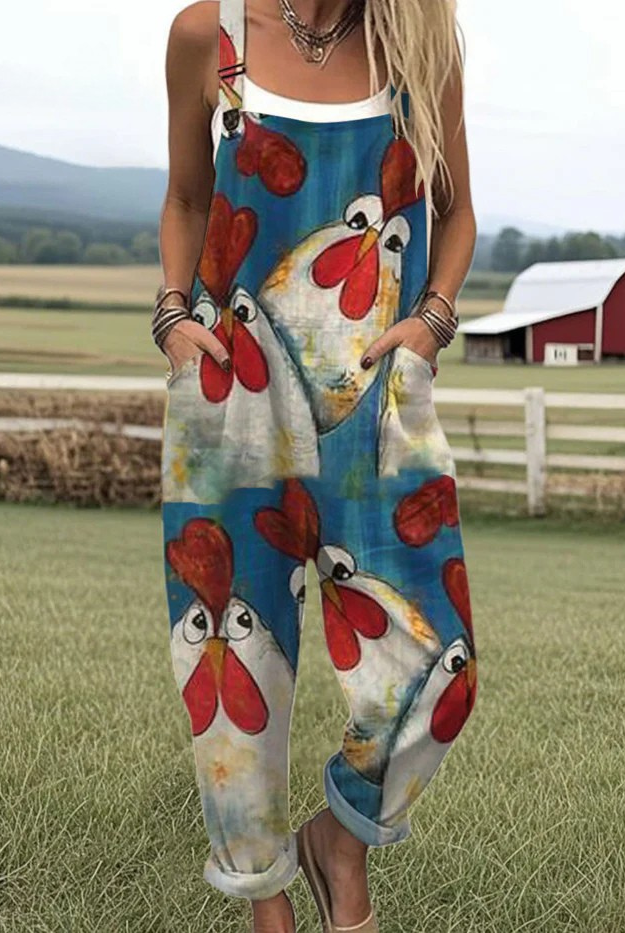 Front view of the Cassia playful chicken jumpsuit in blue with white chicken motifs, showcasing its relaxed fit and rolled cuffs.