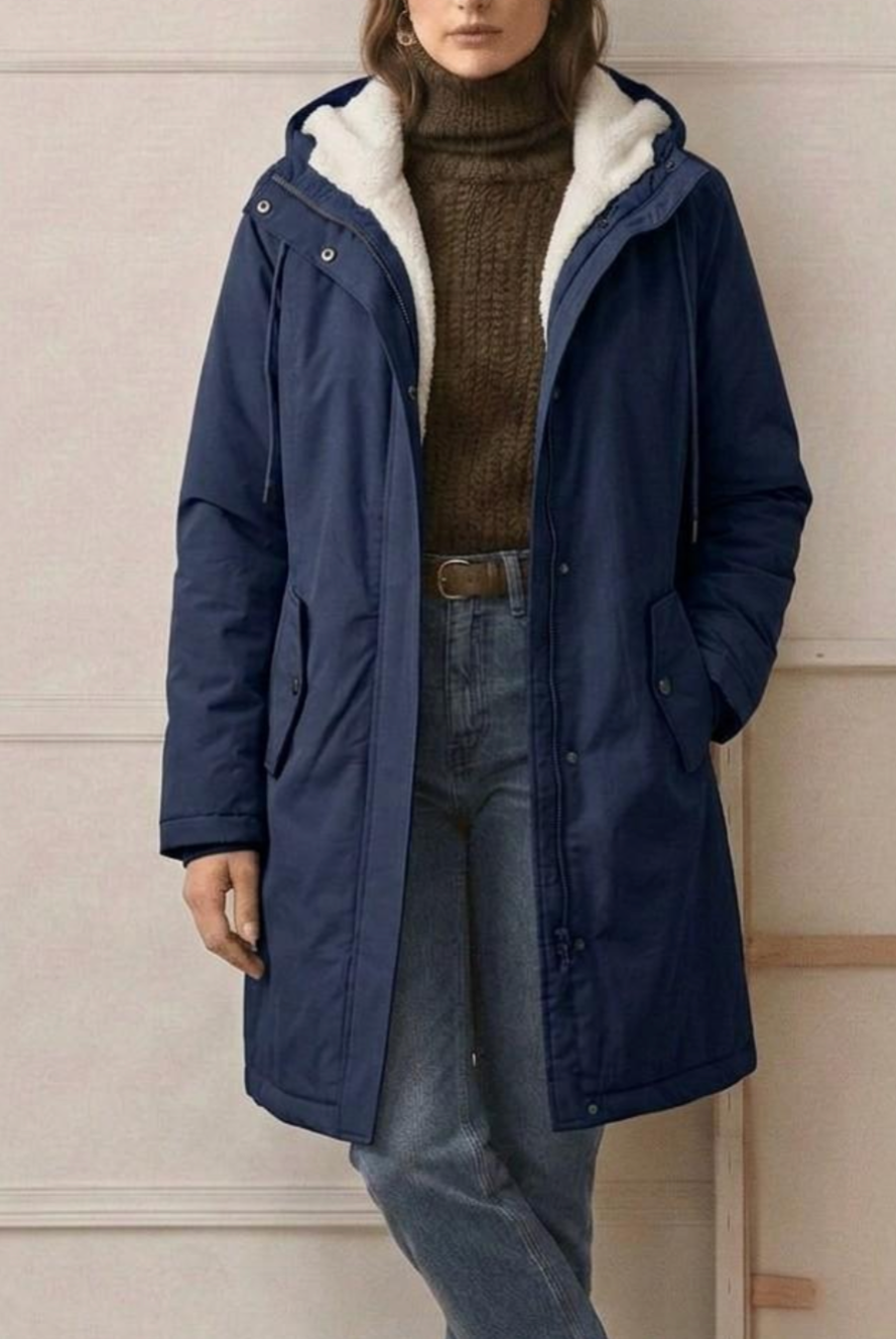 Side profile of the black Elara waterproof parka, highlighting the length and structured silhouette.