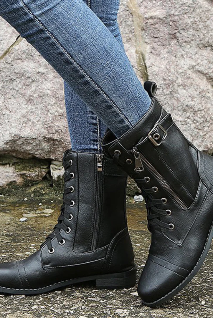 Full-body shot of a woman wearing the Elara orthopedic comfort boots, styled for a rainy autumn day, highlighting their waterproof design.