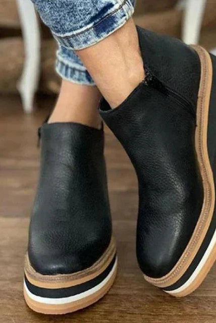 Overhead shot of a pair of beige Elara casual wedge ankle boots, emphasizing the sleek slip-on design.