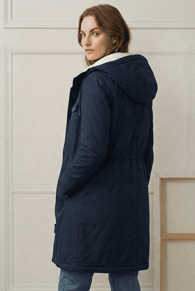 Close-up of the midnight navy Elara parka's waterproof fabric texture and quality stitching.