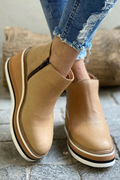 Detailed shot of the comfortable cushioned wedge sole on a dark blue Elara casual wedge ankle boot.