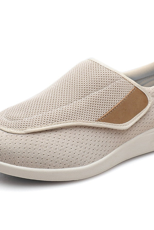 A pair of beige Elara women's comfort shoes positioned on a clean surface, emphasizing their soft appearance.