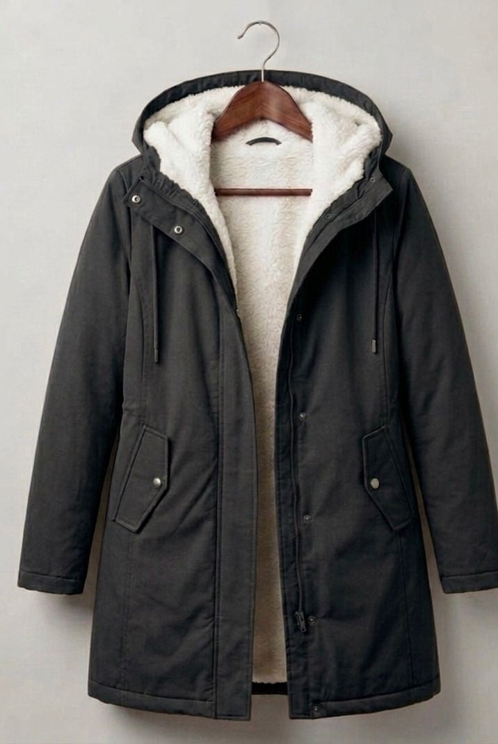 Close-up of the deep, fixed storm hood on the grey Elara waterproof parka, designed for maximum coverage.