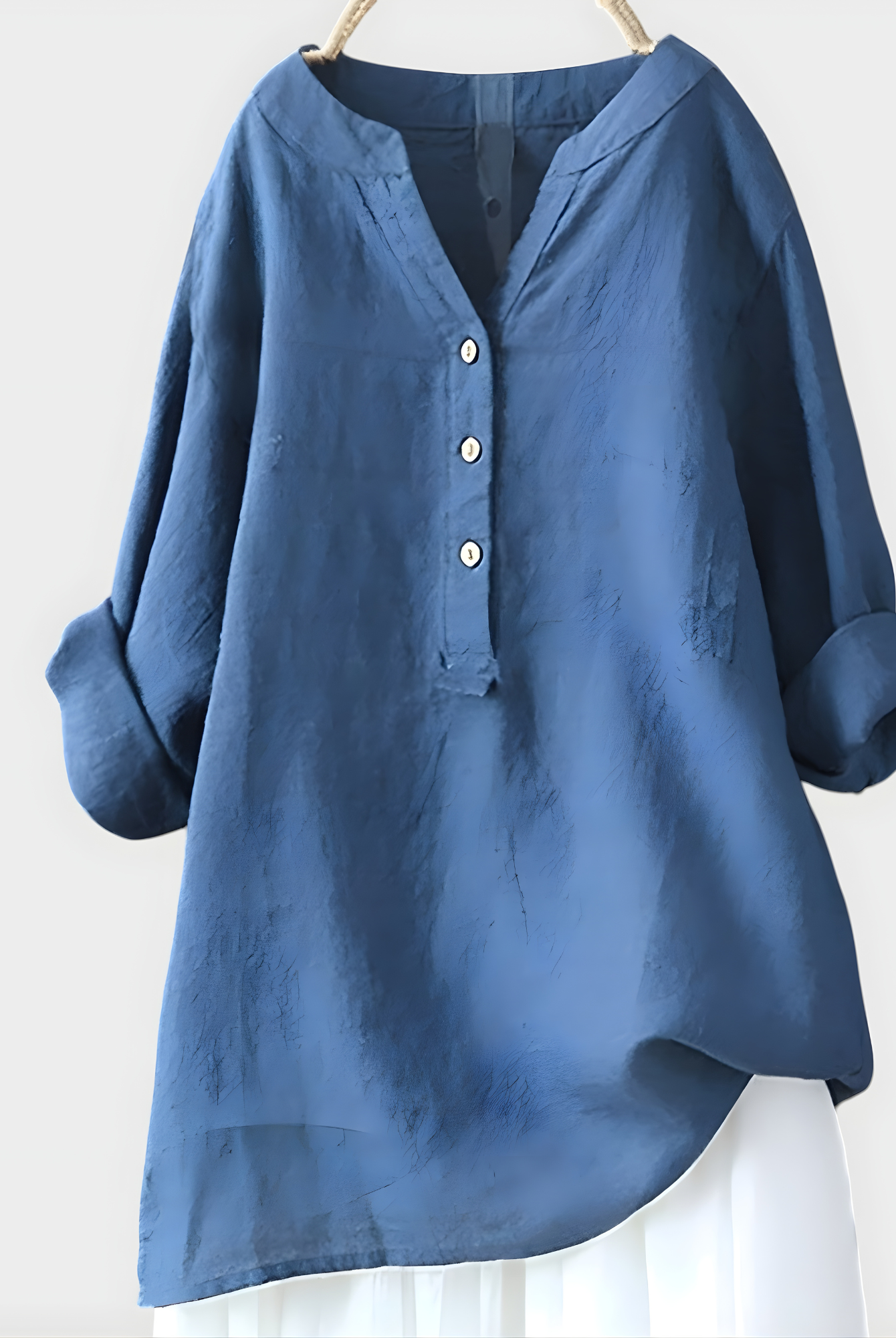 Woman walking outdoors, wearing the Elara elegant cotton-linen blouse in navy blue, comfortable and chic.