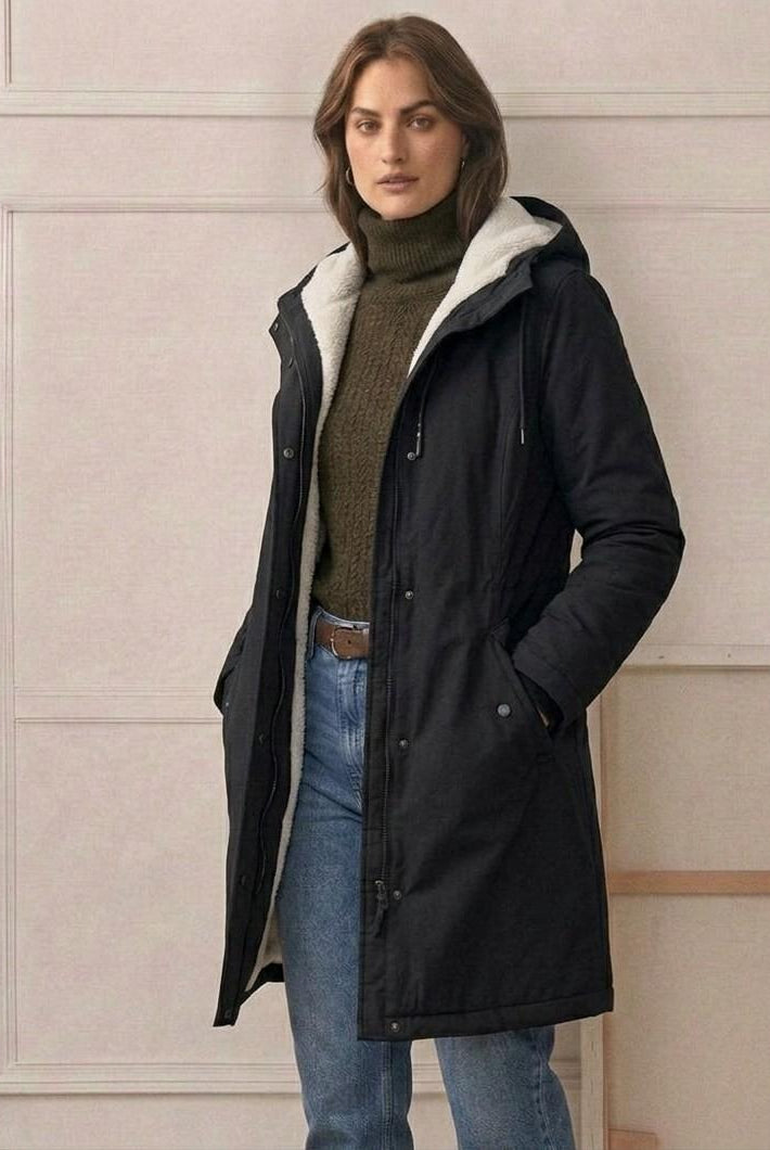 Three-quarter view of the black Elara parka, demonstrating its flattering tapered waist design.