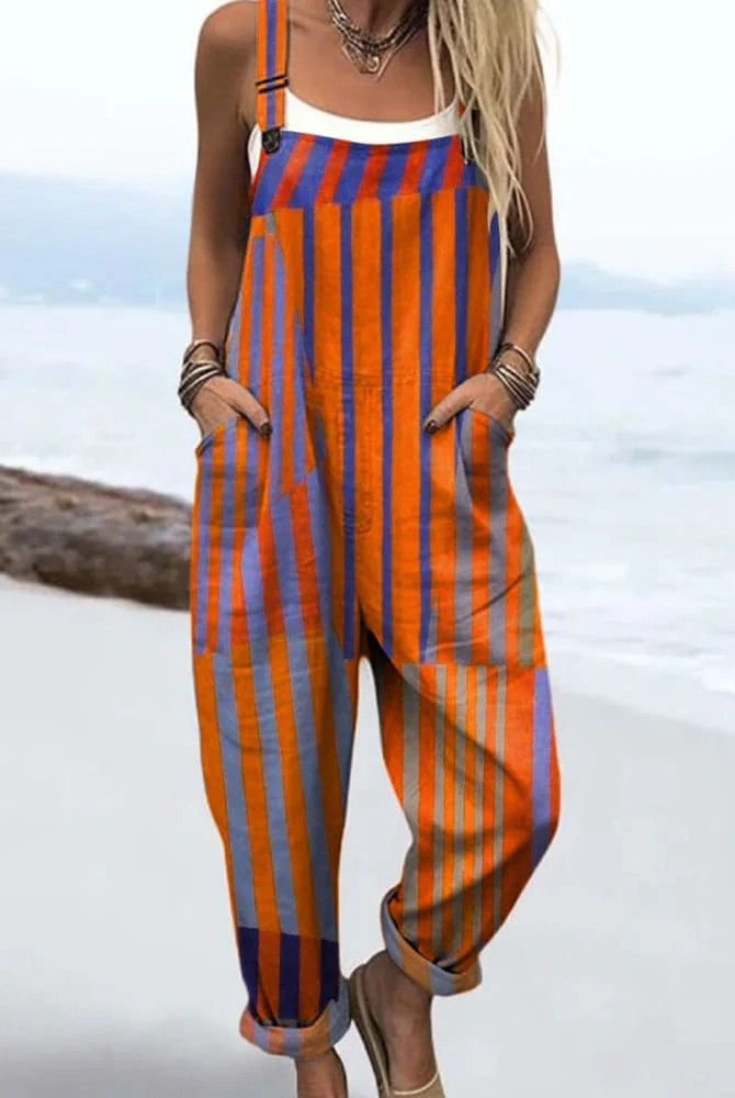 Front view of the Elodie striped relaxed jumpsuit in vibrant orange, blue, and violet, showcasing the adjustable straps and deep pockets on a model.