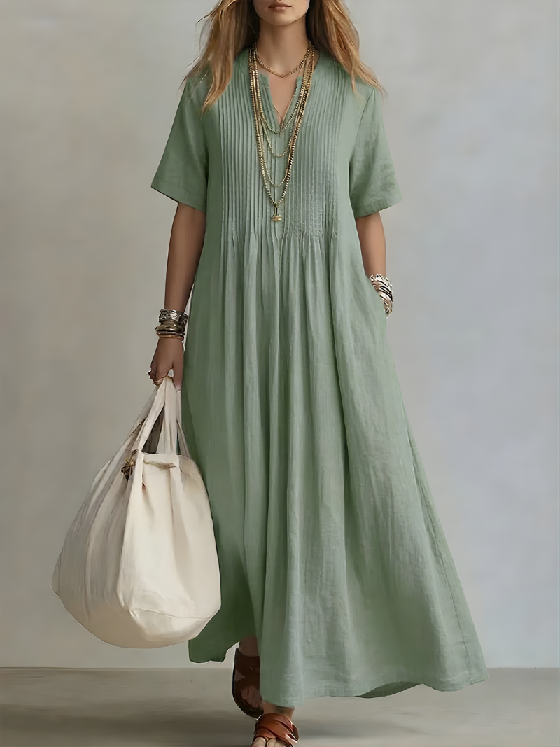 Close-up detail of the V-neckline and short sleeves on the blue Estelle maxi dress, highlighting fabric texture.