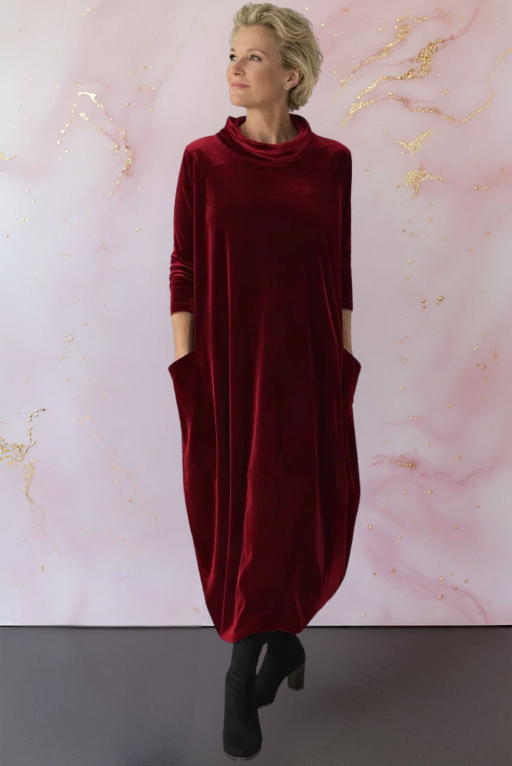 Close-up detail of the modern stand-up collar and soft texture of the luxurious velvet maxi dress fabric.
