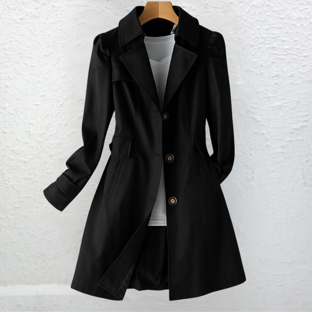 Woman walking in a city park, wearing the khaki Estelle elegant summer trench coat with casual attire.