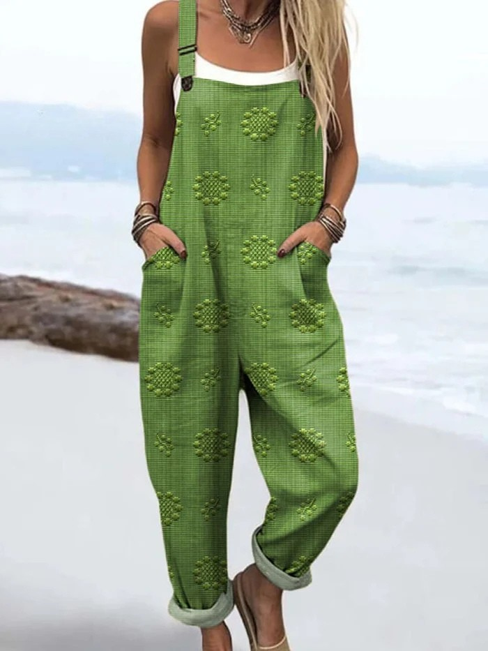 Front view of a woman wearing the Evanthe floral pattern jumpsuit in green, showcasing the relaxed fit.