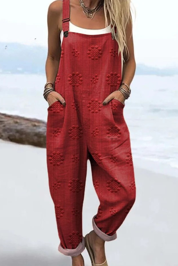 Side profile of the Evanthe floral pattern jumpsuit, showing the adjustable straps and deep front pockets.