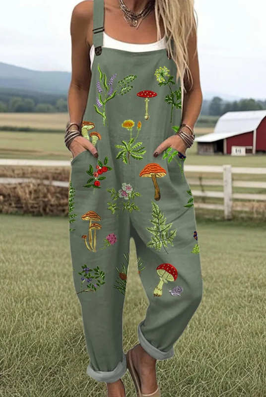 Front view of the Fiona embroidered nature jumpsuit in earthy green, showcasing the delicate mushroom and leaf embroidery details on the bib and soft fabric texture.