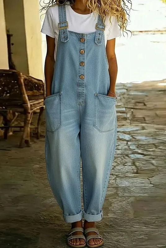 Close-up detail of the adjustable shoulder straps and chest pocket on the Hadley soft denim overalls, highlighting the fabric texture.