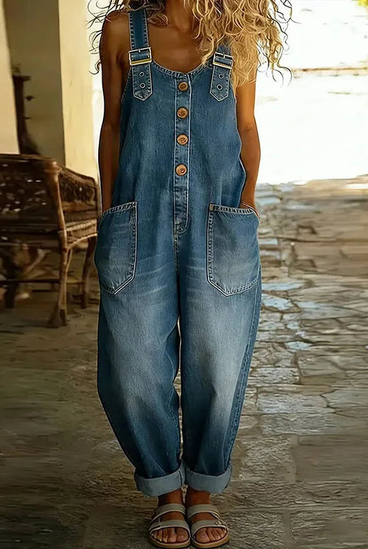 Side profile of a model styling the Hadley wide-leg denim overalls, demonstrating the comfortable drape and silhouette.