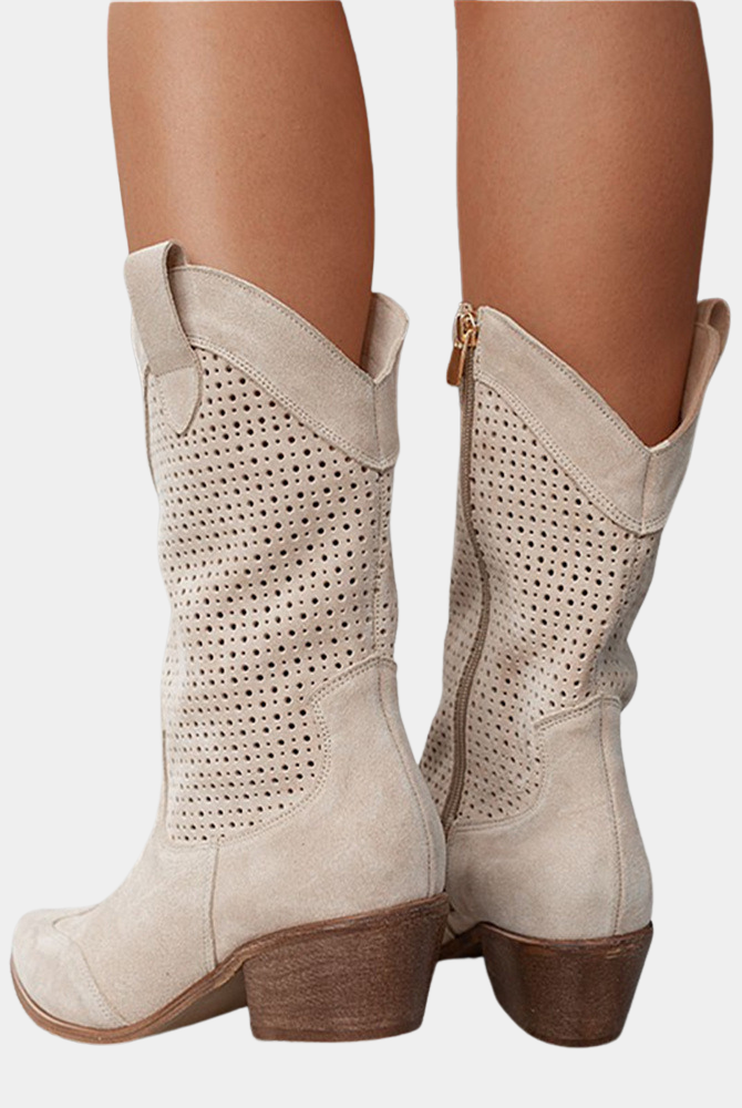 A woman confidently walking outdoors wearing the Hadley orthopedic cowboy boots, illustrating their stability and comfort.