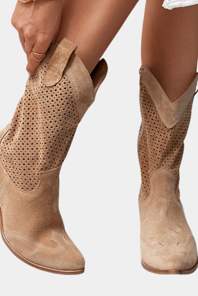 A pair of Hadley orthopedic cowboy boots in beige, styled with a flowing dress for a chic, comfortable look.