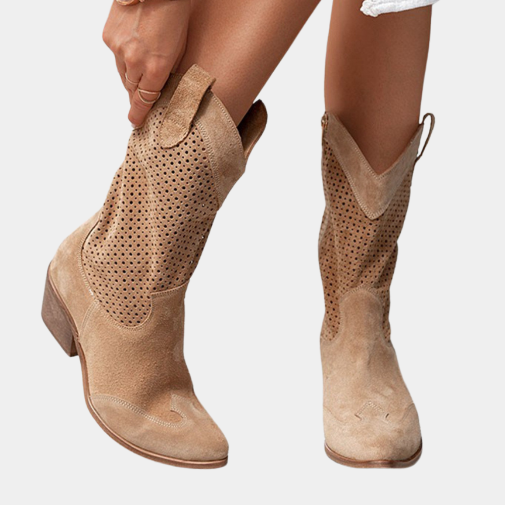 A pair of Hadley orthopedic cowboy boots in beige, styled with a flowing dress for a chic, comfortable look.