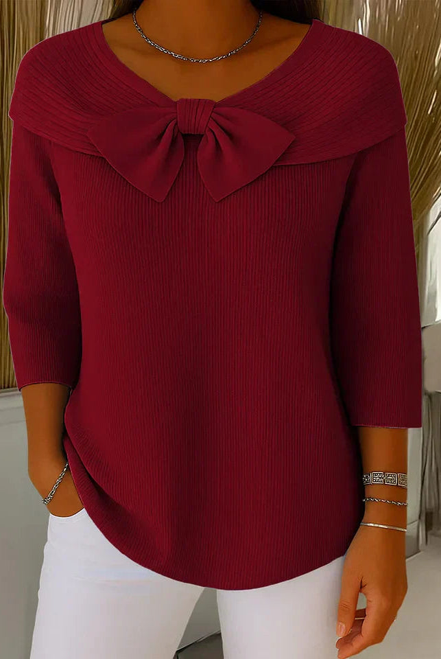 Lifestyle shot of the Isolde elegant knitted top worn with tailored trousers, demonstrating its versatility for office wear.