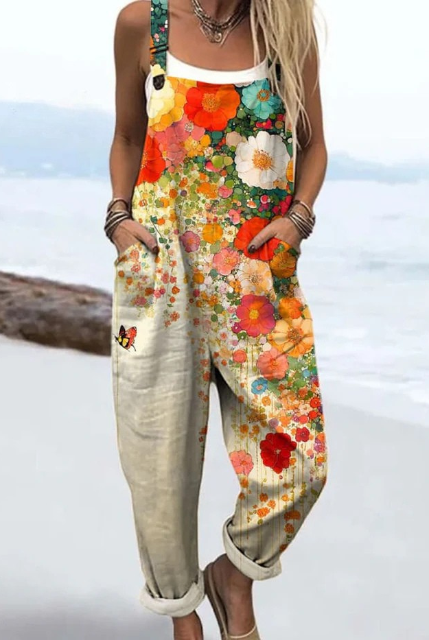 Front view of the Kaelen Floral Breeze Jumpsuit, showcasing its relaxed fit and vibrant orange, white, pink, and turquoise floral pattern.