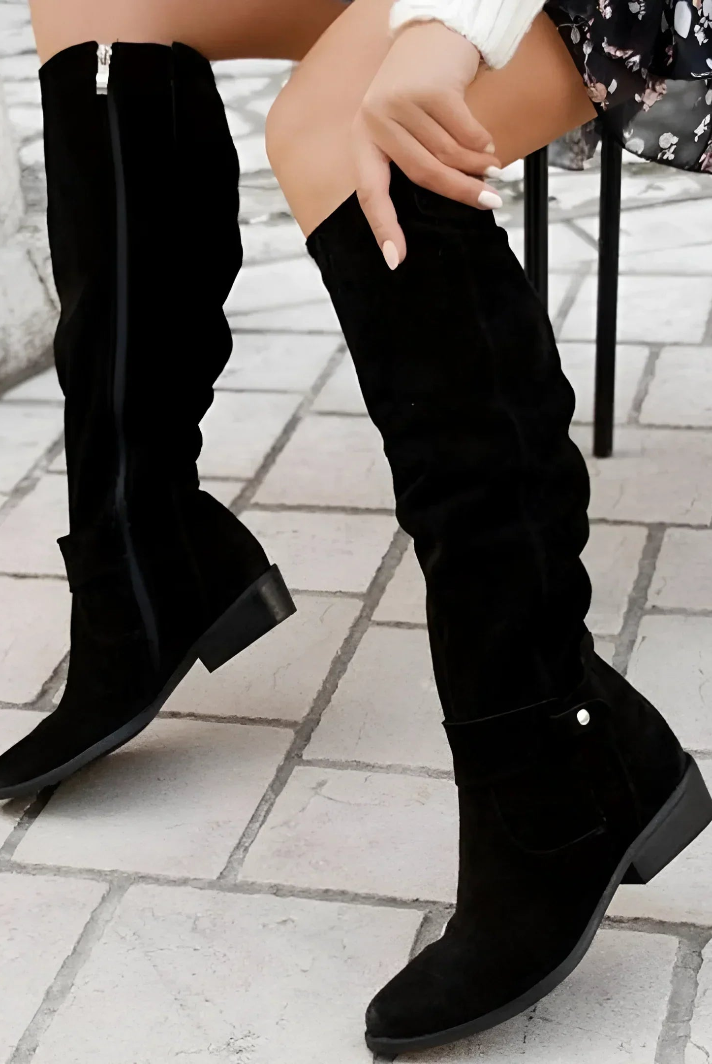 Overhead view of two pairs of Kalina knee-high suede boots in contrasting colors, arranged artfully to show material quality.