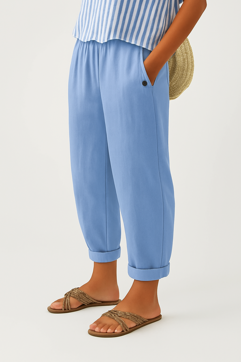 Overhead flat lay of Kallista linen-cotton blend trousers in a soft light blue, emphasizing their relaxed design.