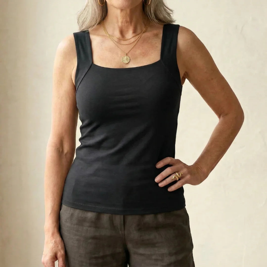 Model sitting casually in the coffee Keisha comfort bra tanktop, illustrating everyday wear.