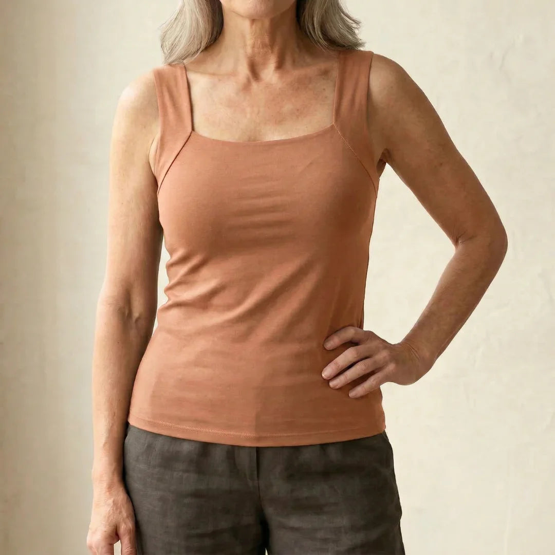Detail of the bottom hem on the nude Keisha comfort bra tanktop, showing its finish.