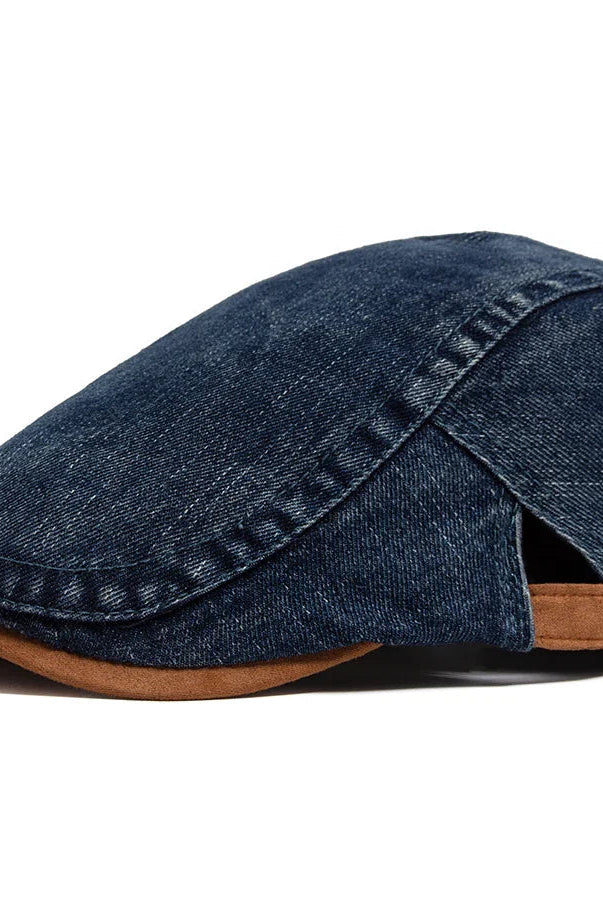 Close-up of the high-quality denim fabric on the flat cap, revealing its intricate weave and rich texture.