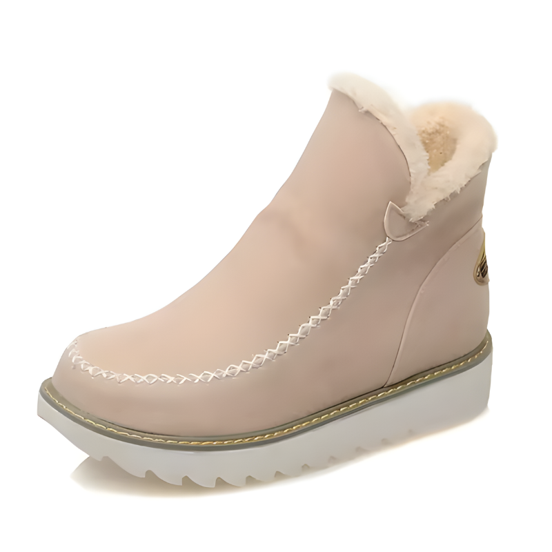 Lifestyle image of a woman sitting on a bench, wearing black Kira orthopedic ankle boots with casual attire.
