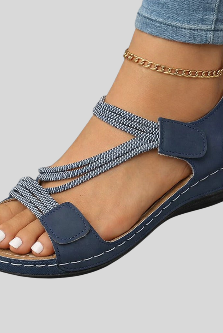 Pair of light pink Liana orthopedic comfort sandals displayed from a front-top angle, showcasing the adjustable straps and cushioned footbed on a clean background.