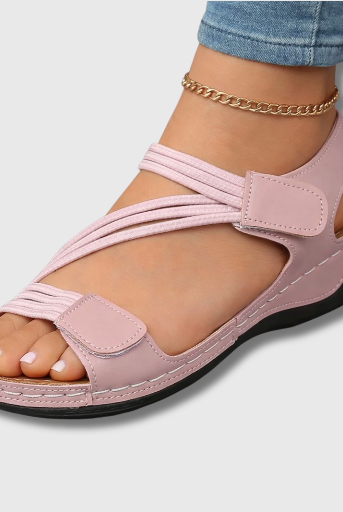 Close-up side view of a black Liana orthopedic comfort sandal, highlighting the ergonomic arch support and textured non-slip sole for secure walking.