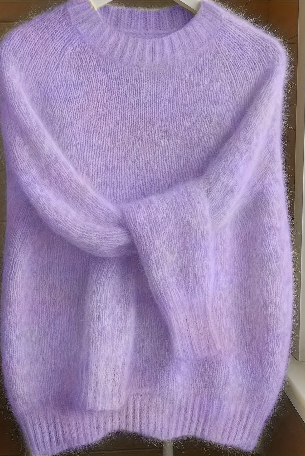 Close-up detail of the fine gauge knit texture on the shoulder of the purple Lila cashmere-blend sweater.