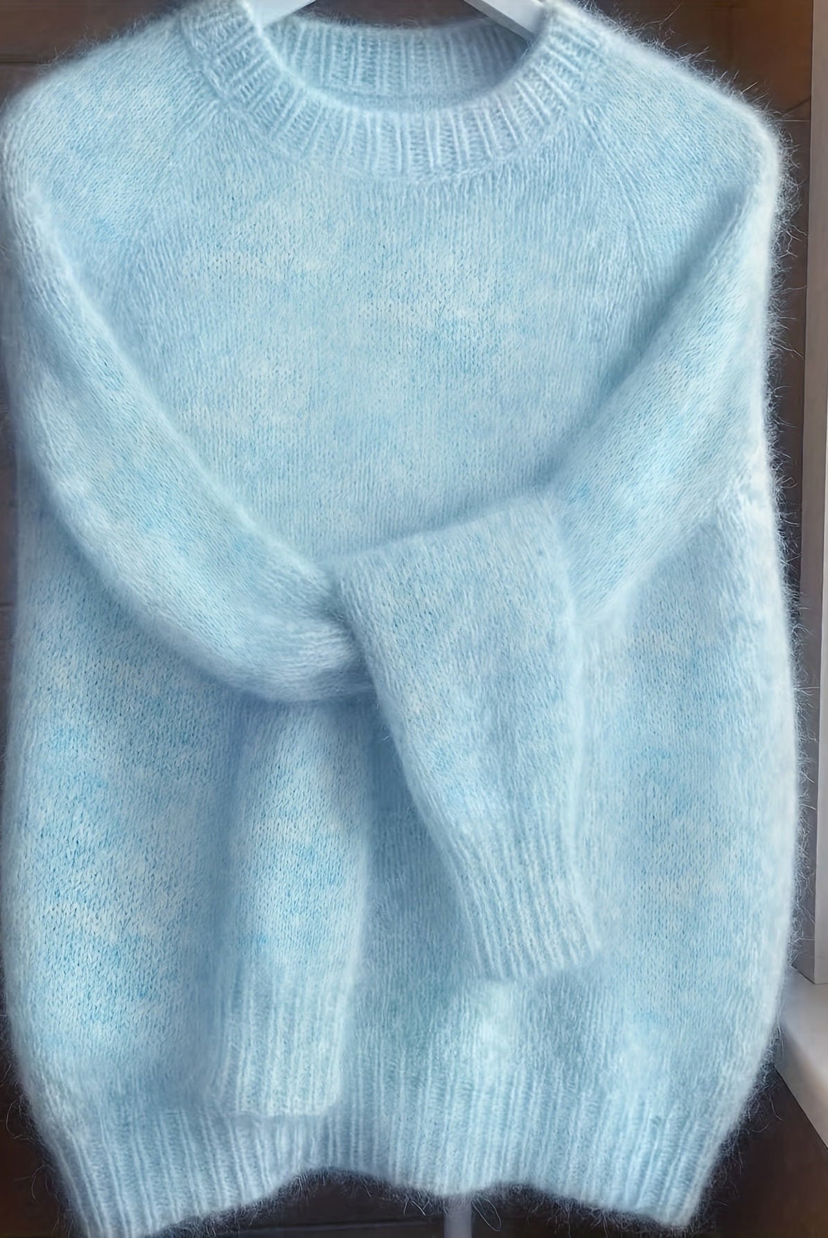 Overhead shot of the blue Lila cashmere-blend sweater, displaying its full design and rich color.