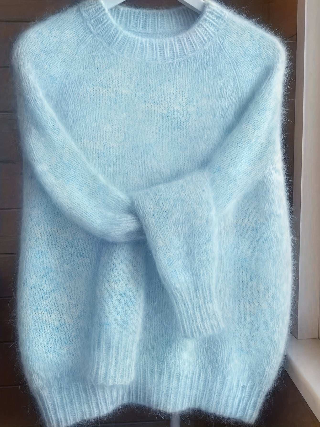 Overhead shot of the blue Lila cashmere-blend sweater, displaying its full design and rich color.
