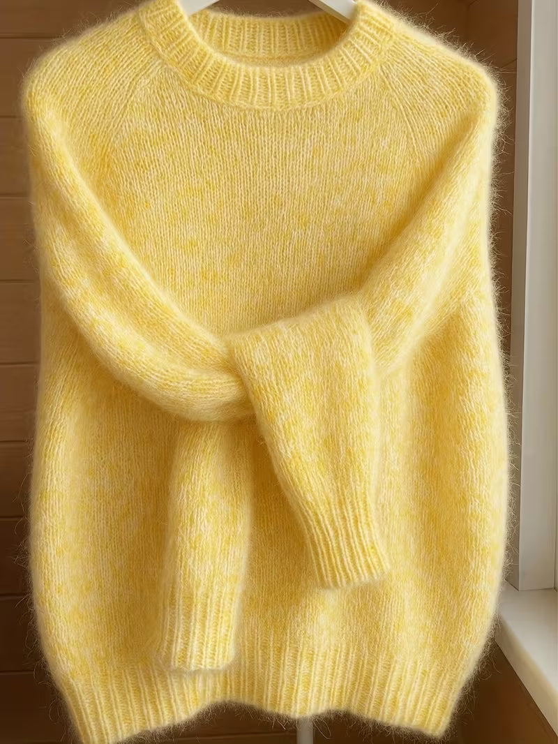 Detail of the cuff on the yellow Lila cashmere-blend sweater, showing the quality stitching and soft fabric.