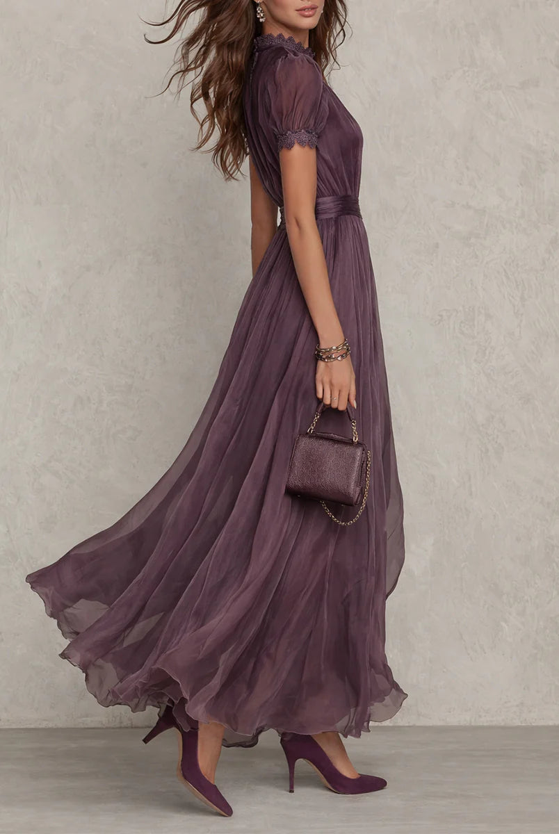 Side profile of the elegant purple chiffon maxi dress, highlighting the delicate lace trim on the sleeves.
