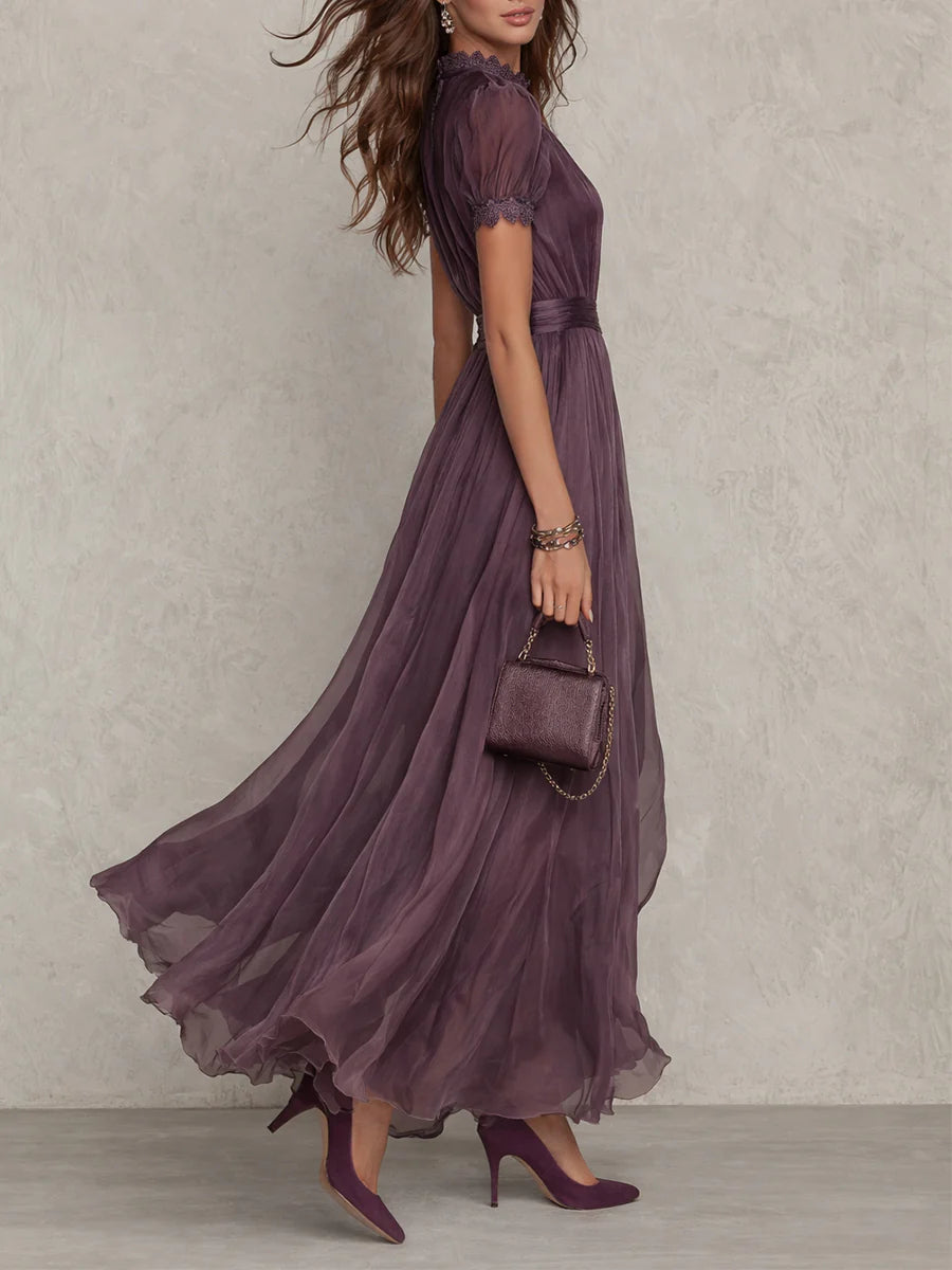 Side profile of the elegant purple chiffon maxi dress, highlighting the delicate lace trim on the sleeves.