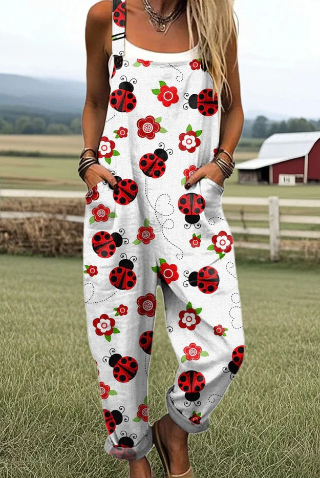 Front view of the Elara ladybug and floral print jumpsuit, showcasing its relaxed fit and white fabric with red and green patterns.