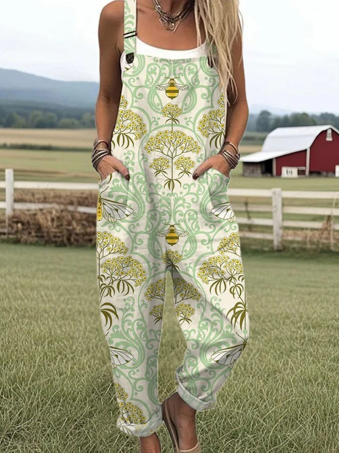 Front view of the Seraphina whimsical countryside jumpsuit, showcasing its green and gold bee and blossom print, relaxed fit, and adjustable straps.