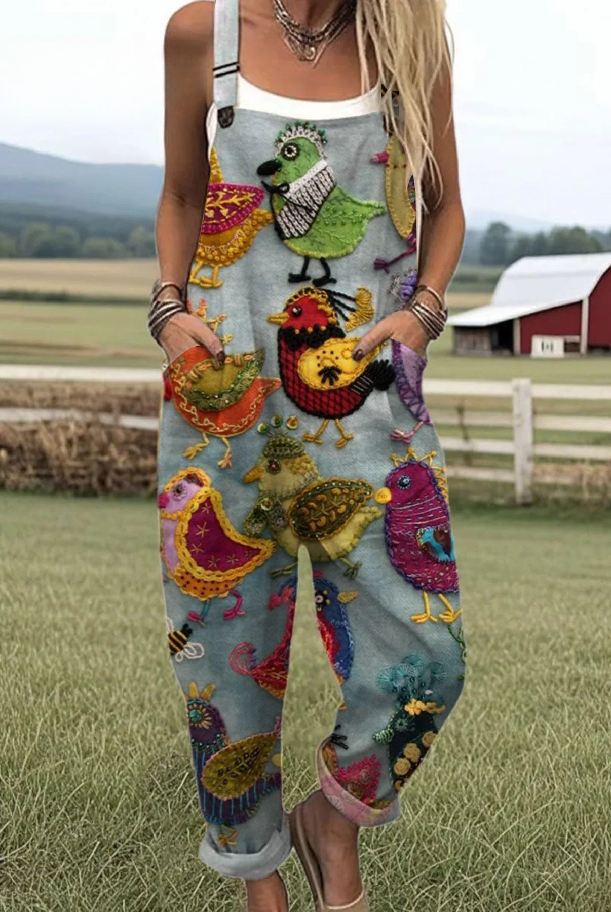 Front view of the Serena embroidered bird jumpsuit on a model, showcasing its burnt orange color and wide-leg design.