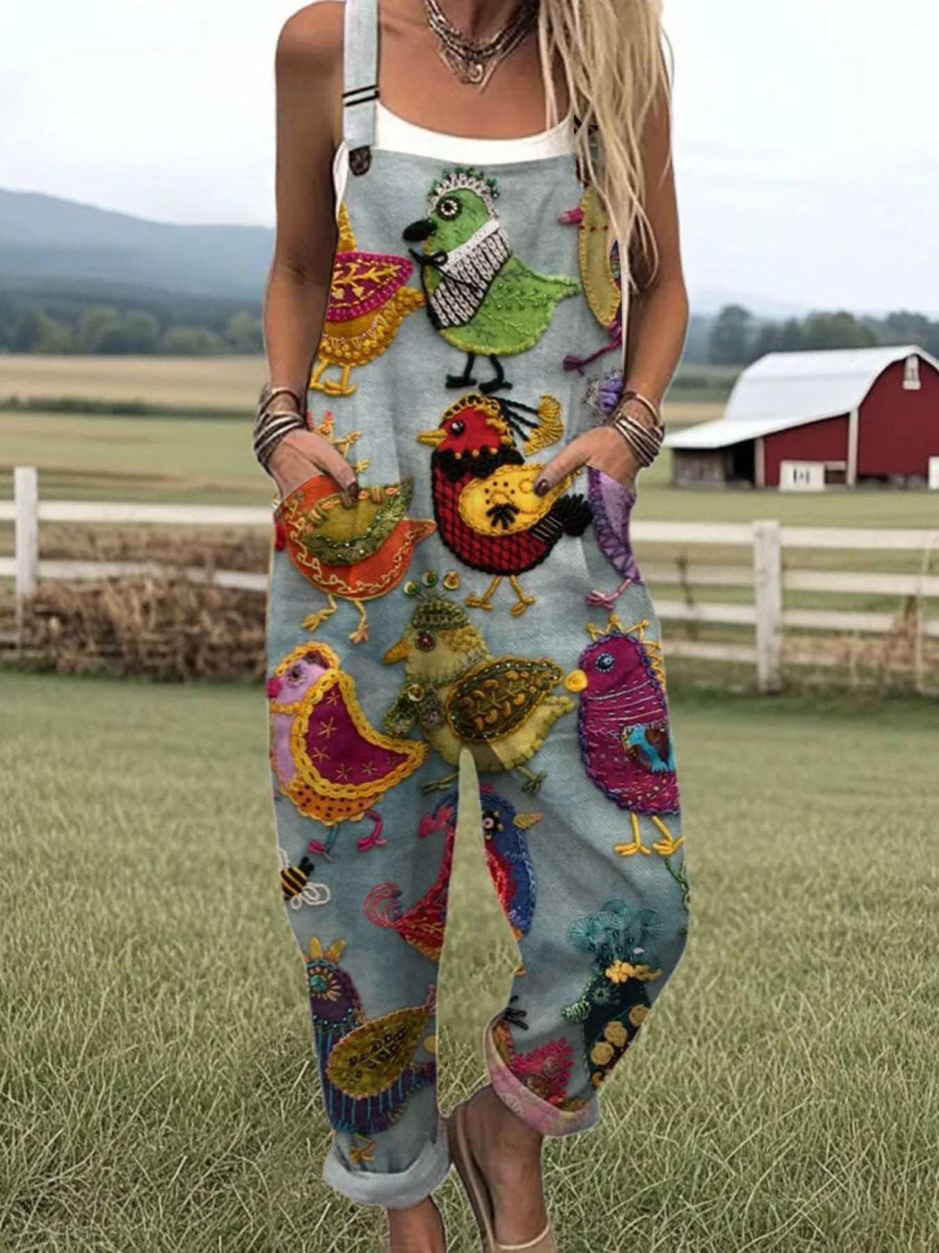 Front view of the Serena embroidered bird jumpsuit on a model, showcasing its burnt orange color and wide-leg design.