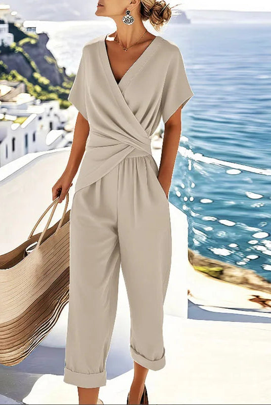 Front view of the women's refined two-piece outfit in apricot, showcasing the elegant wrap-front top and cropped trousers.