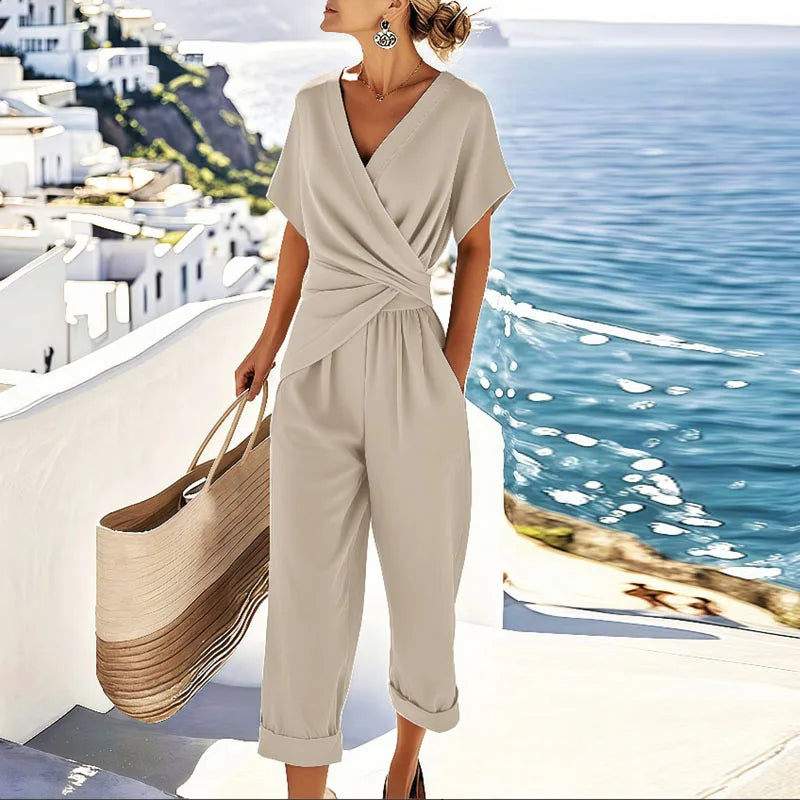 Front view of the women's refined two-piece outfit in apricot, showcasing the elegant wrap-front top and cropped trousers.