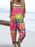 Front view of the Paloma vibrant geometric jumpsuit featuring a pink and yellow grid pattern, worn by a model in a relaxed pose.